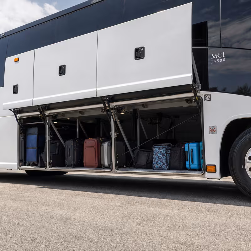 Party bus interior with wraparound leather seating and LED lighting in Coral Gables
