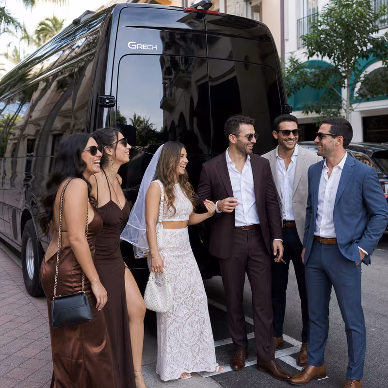 Group boarding a white charter bus for Bachelor & Bachelorette Transportation transportation in Coral Gables