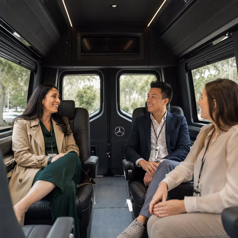 Group boarding a white charter bus for Corporate Transportation transportation in Coral Gables