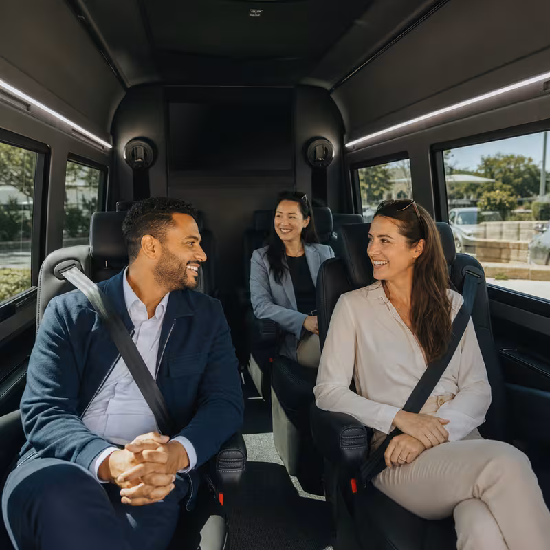 Passengers loading luggage while boarding an Coral Gables group shuttle