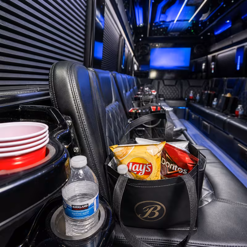 Party bus interior with wraparound leather seating and LED lighting in Coral Gables